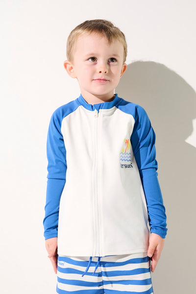 Veste de bain anti-UV - Fidji pour enfant, coloris bleu et blanc, idéale pour protection solaire en bord de mer.